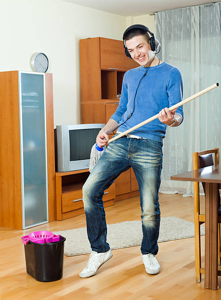 istock Happy man washing parquet floor with mop 535917867