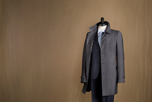Mens two piece suit with coat displayed on a mannequin photograhed against a canvas background