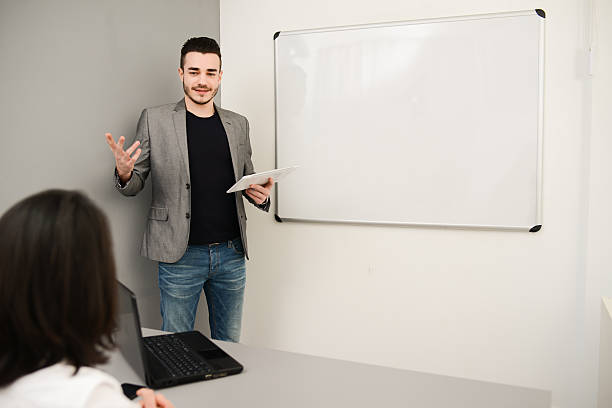 istock young business man or teacher showing data on white board 535918963