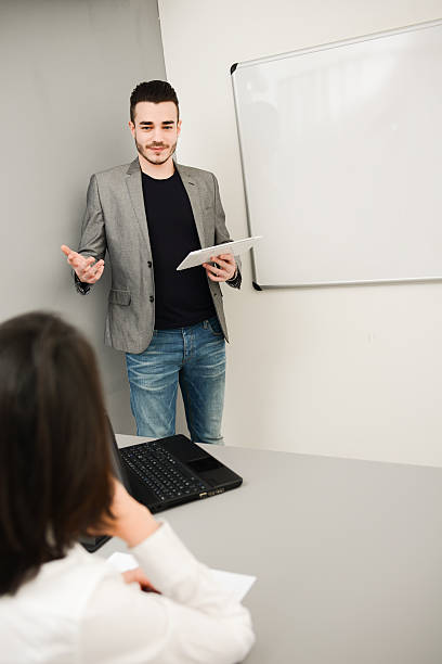 istock young business man or teacher showing data on white board 535918965