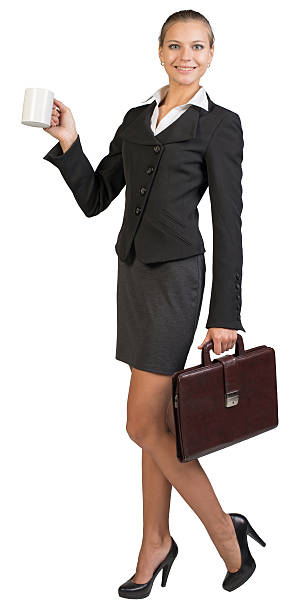 istock Businesswoman holding mug and briefcase 535921099
