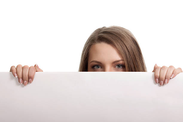 istock Woman looking over blank card in the studio 535931915