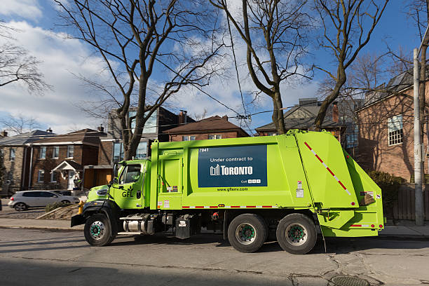 Toronto, Canada - January 22, 2015: GFL garbage truck down a street in Toronto during the day