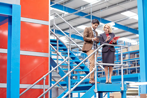 istock Businesspeople in factory working on digital tablet 535932885