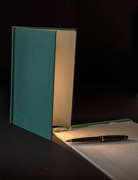 istock Open Book Illuminating Paper with copy space 535934083