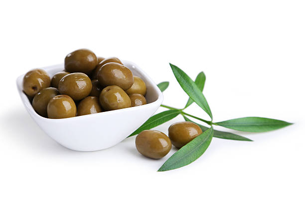istock Green olives in bowl isolated on white 535934127