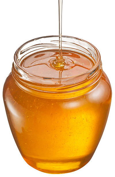 istock Honey flowing into glass jar. 535934419