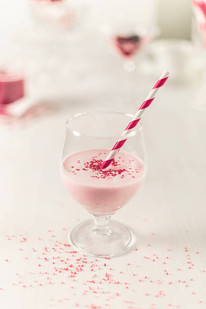 Fancy milkshake in clear plastic cup with a straw and copy space