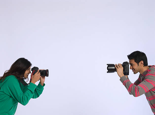 istock Couple Photographing Each Other In Studio 535935457