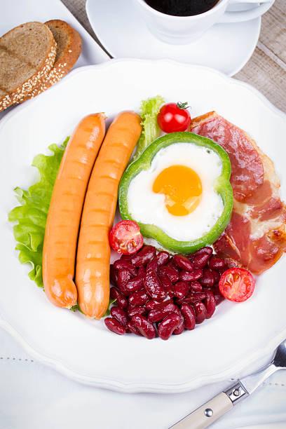 Fried egg, sausages, bacon and red beans
