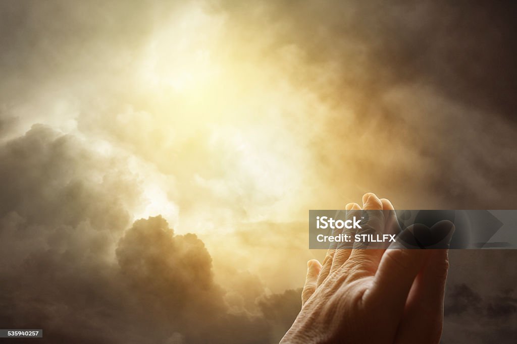 Prayer Hands together praying in bright sky 2015 Stock Photo