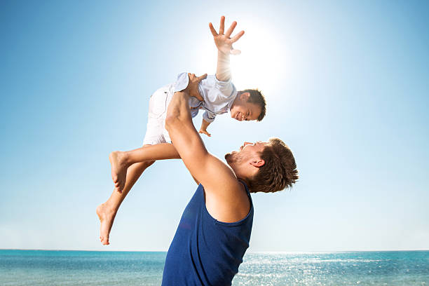 istock Playful father and son at the beach. 535941595