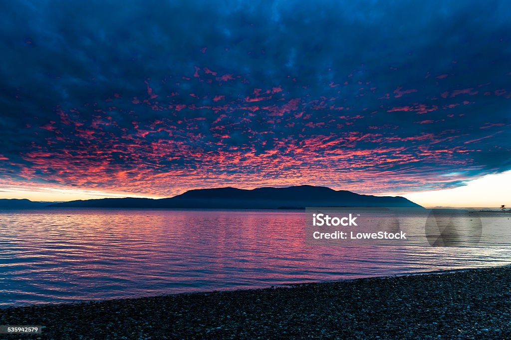 Island Sunset A dramatic view of Orcas Island, in the Puget Sound area of western Washington, is enveloped in a fiery sunset seen along Legoe Bay on the shores of Lummi Island. Rosario Stock Photo