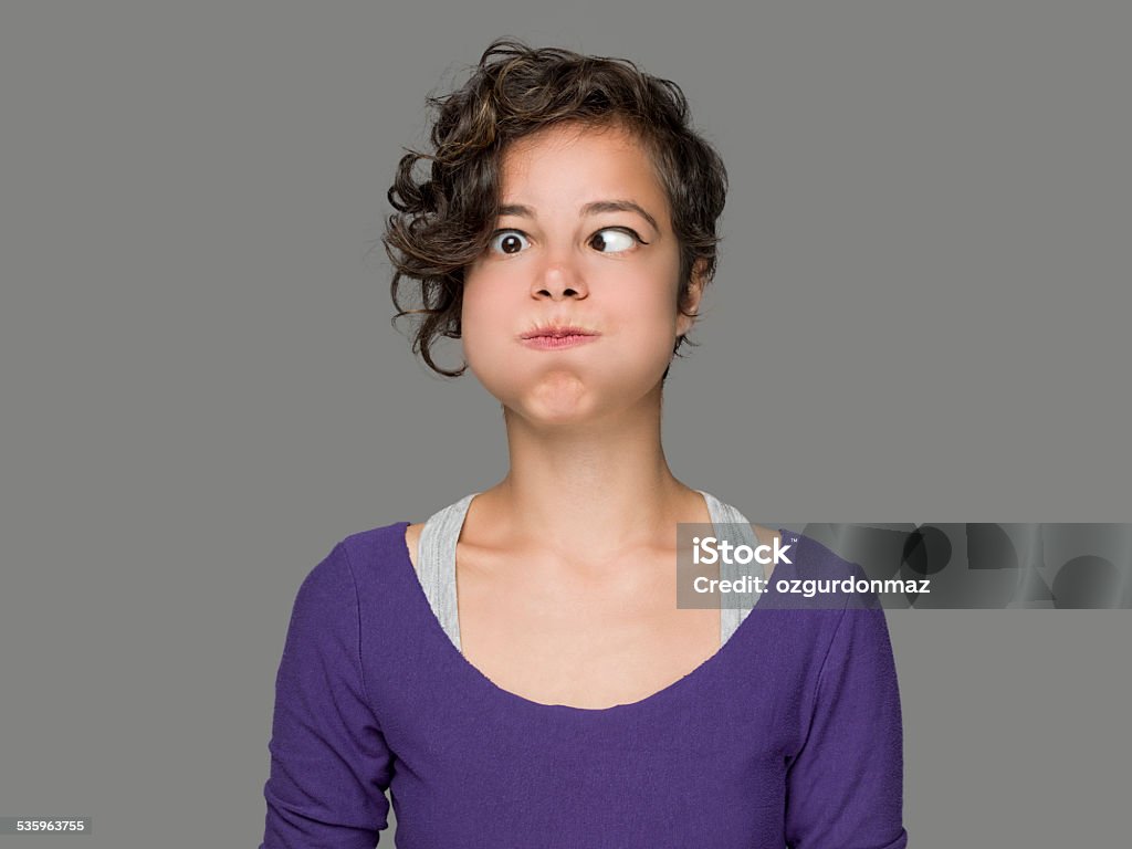 Pretty woman with bizarre expression Pretty woman making a face on a gray background,studio shot Mouthwash Stock Photo