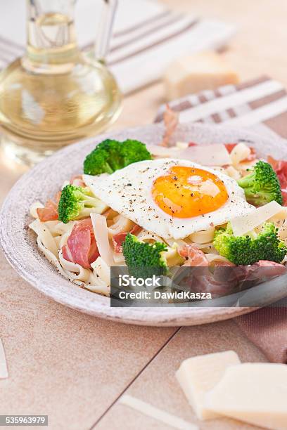 Tagliatelle Pasta With Broccoli Prosciutto And Fried Egg Stock Photo - Download Image Now