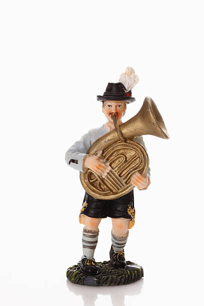 istock Bavarian figurine playing tuba on white background 535964971