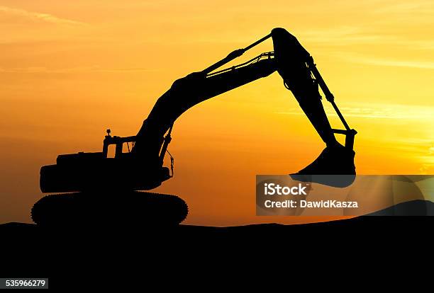 Silhouette Of Excavator Loader At Construction Site With Raised Stock Photo - Download Image Now