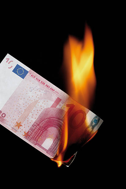 istock 10 euro note burning against black background 535966451