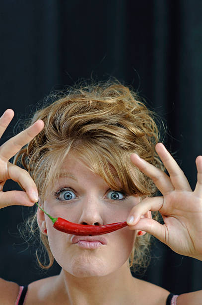 istock Young woman with pepperoni, portrait 535966745