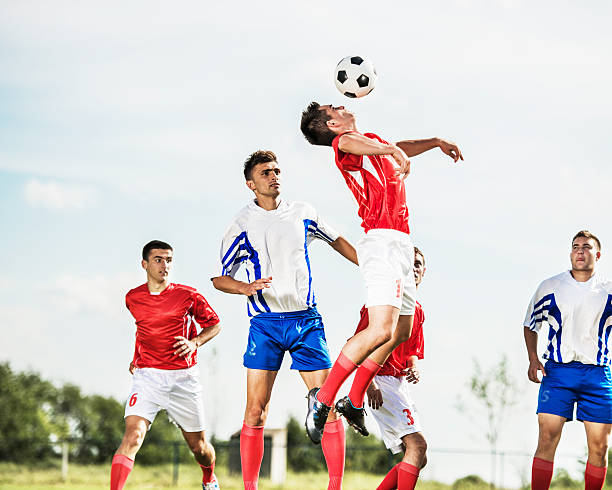 istock Soccer player heading the ball against the sky. 535967975