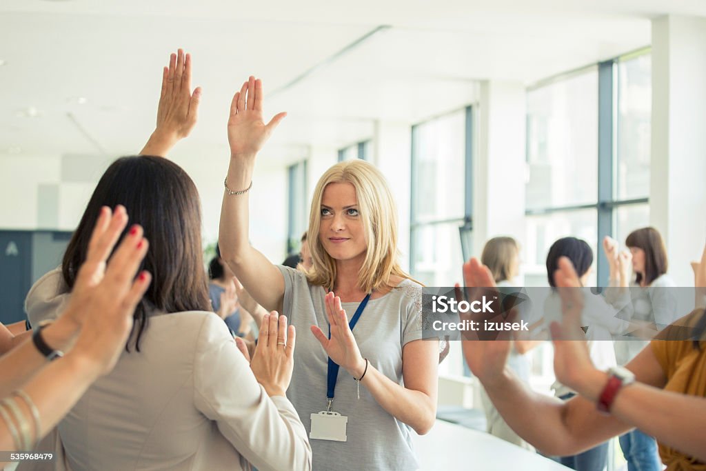Group therapy for women Large group of women attending a training, playing with hands together. 2015 Stock Photo