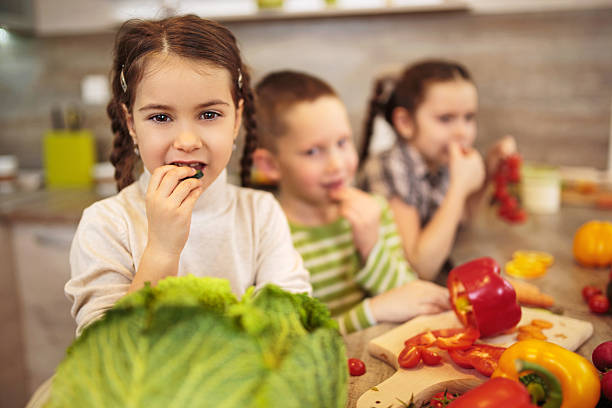 istock Little girl eating vegetable. 535969217