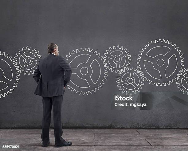 Businessman And Gears Stock Photo - Download Image Now - Domestic Room, 2015, Adult