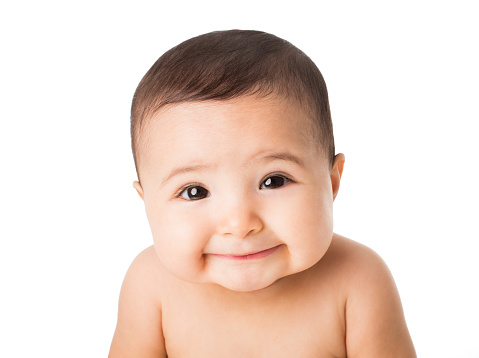 Portrait of a happy baby girl smiling isolated over white background