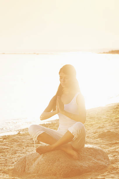 istock yoga lotus meditation position front to seaside 535972097