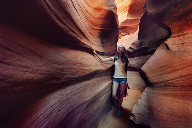 Tourist inside Antelope Canyon Young woman inside Lower Antelope Canyon in Arizona, USA antelope canyon stock pictures, royalty-free photos & images