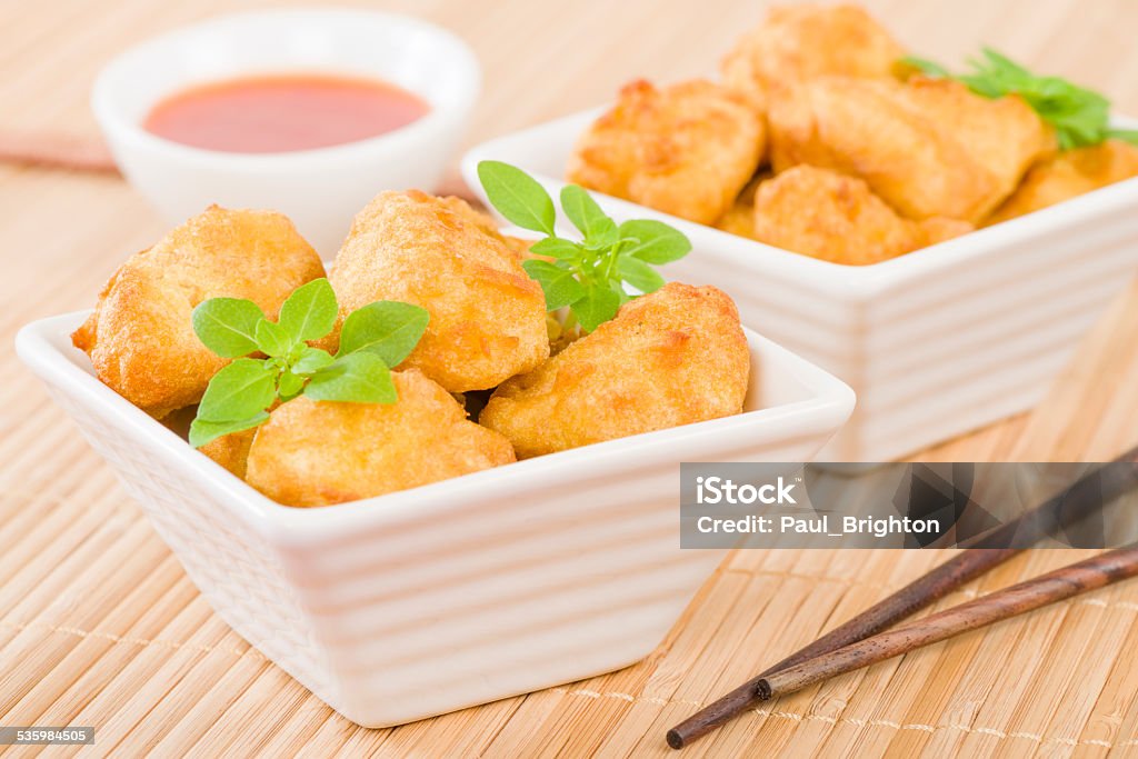 Chicken Nuggets Chicken Nuggets - Battered and deep fried chicken pieces served with chilli sauce. 2015 Stock Photo