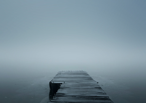 Wooden jetty over frozen lake