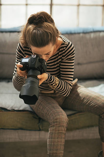 istock young woman using modern dslr photo camera 535987847