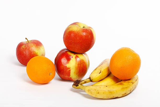 istock Fresh ripe bananas bunch and orange apple 535987899