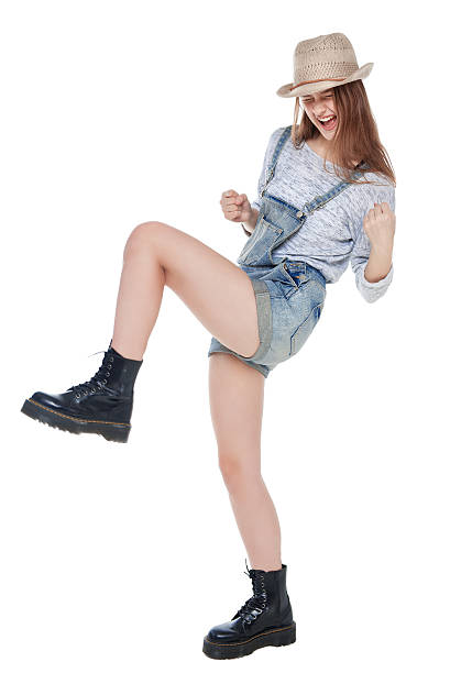 молодой моды девушка в джинсах комбинезон с да жест изолированные - hip expressing positivity full blue стоковые фото и изображения