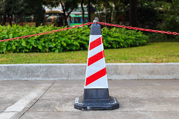 istock Red-white traffic cone and chain on street 535988939