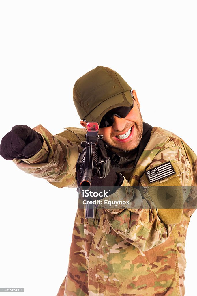 Young army soldier assaulting position Young army soldier with assault riffle slinged on pointing out something to be attacked in the battlefield isolated over white background 2015 Stock Photo