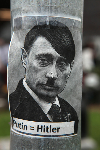 Prague, Czech Republic - May 24, 2014: Sticker depicting Russian president Vladimir Putin as Adolf Hitler and with an equals sign between their names seen in Prague, Czech Republic.