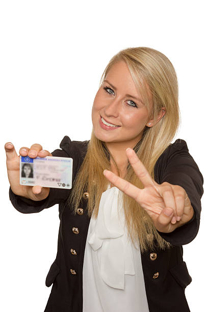 istock Young woman showing her driver's license 535992399
