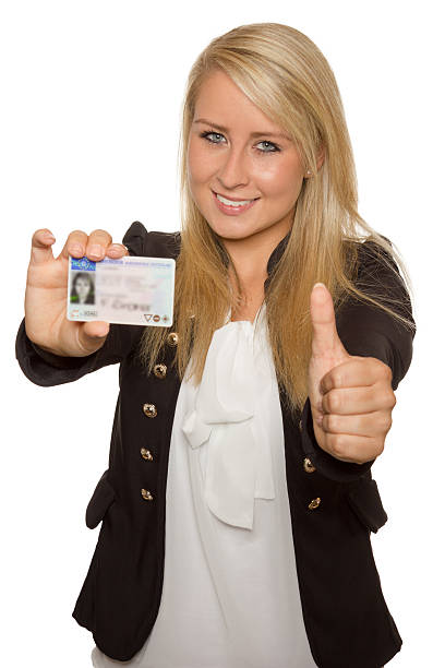 Young woman showing her driver's license stock photo