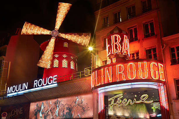 Paris, France - July 11, 2014: Moulin Rouge by night, sign and windmill illuminated in Montmartre, red lights.