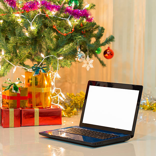 istock laptop with gift box and christmas lights background 536010365