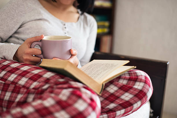 Drinking tea and reading book stock photo