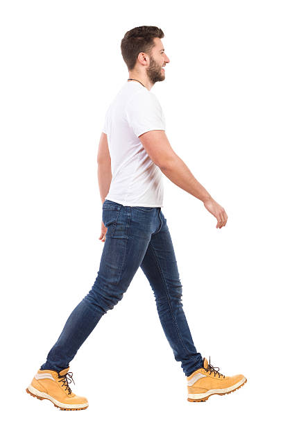 Young man walking in jeans and white t-shirt