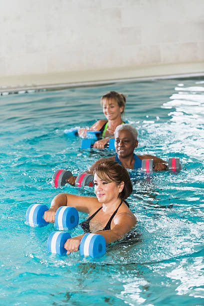 istock Multiracial mature women in water aerobics class 536012317