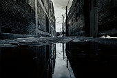 Dark Backstreet and Reflection on a Puddle