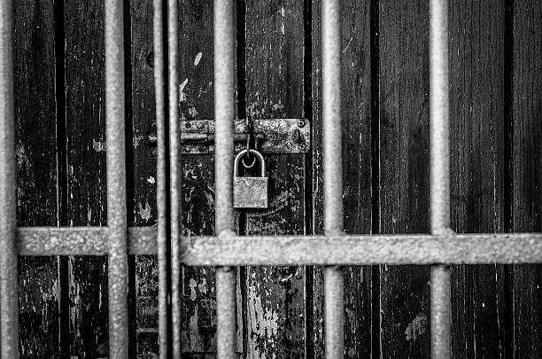 istock locked door with iron bars in front of door 536013263