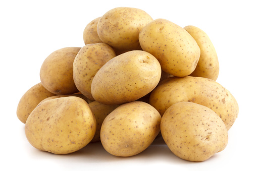 Pile of potatoes arranged on white.