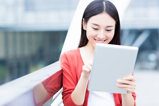 istock cheerful girl with tablet in city 536014877