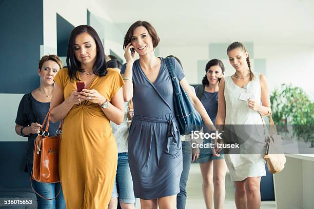 Group Of Women Walking The Hall Stock Photo - Download Image Now - Office, Pregnant, Arrival